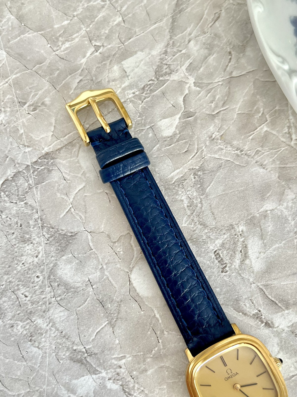 Navy blue textured Omega De Ville watch strap with gold-tone pin buckle