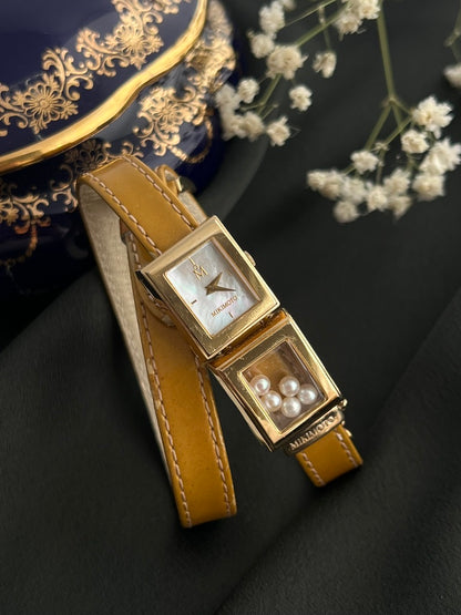 Mikimoto gold-tone moving pearl double-wrap watch with mother-of-pearl dial and tan leather strap