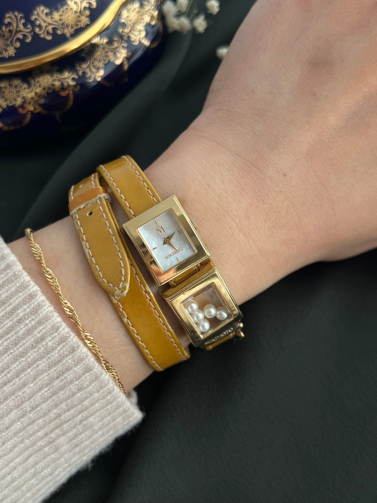 Close worn view of Mikimoto mother-of-pearl dial and five-pearl display watch