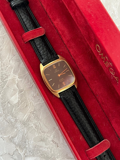 Angled view of Omega De Ville 591.0099 gold-tone cushion case and dark dial