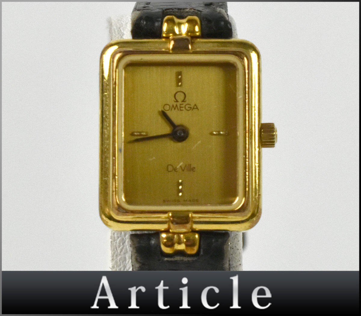 Front view of the Omega De Ville 591.0380 Calibre 1455 gold square watch with champagne dial and black leather strap