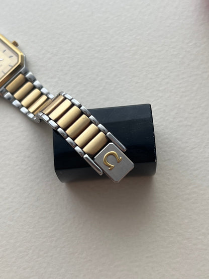 Close-up of the Omega De Ville America champagne dial, polished hour markers and hands.