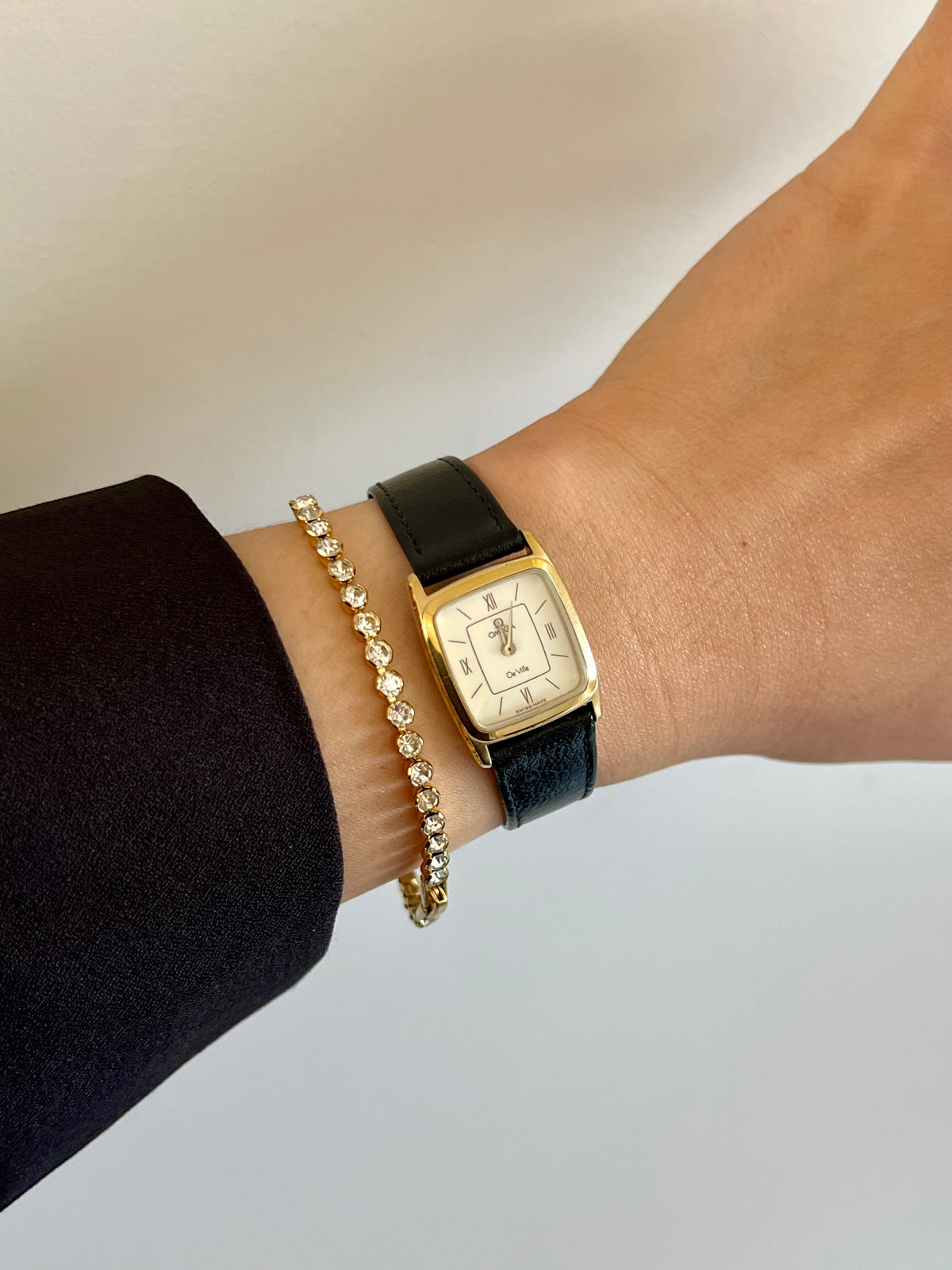 Angled view of the Omega De Ville gold-tone rectangular watch.