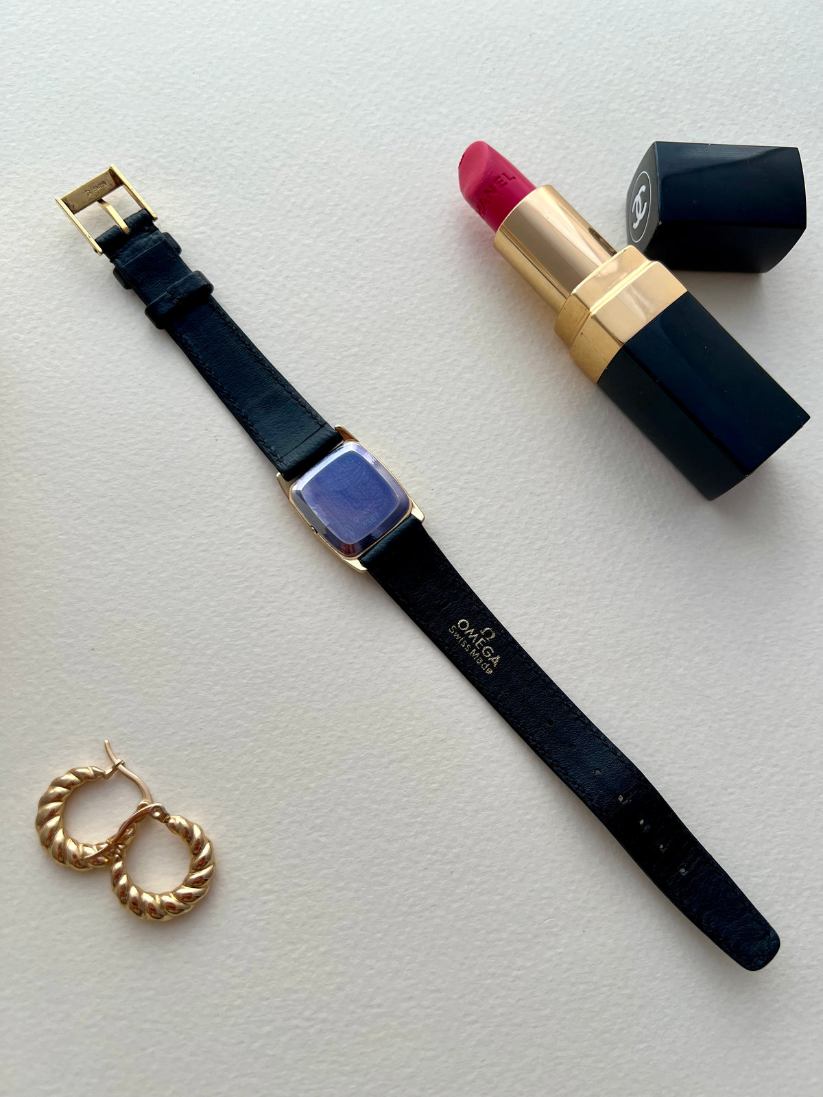 Side view of the gold-tone Omega De Ville case.