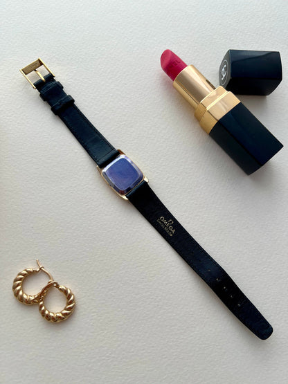 Side view of the gold-tone Omega De Ville case.