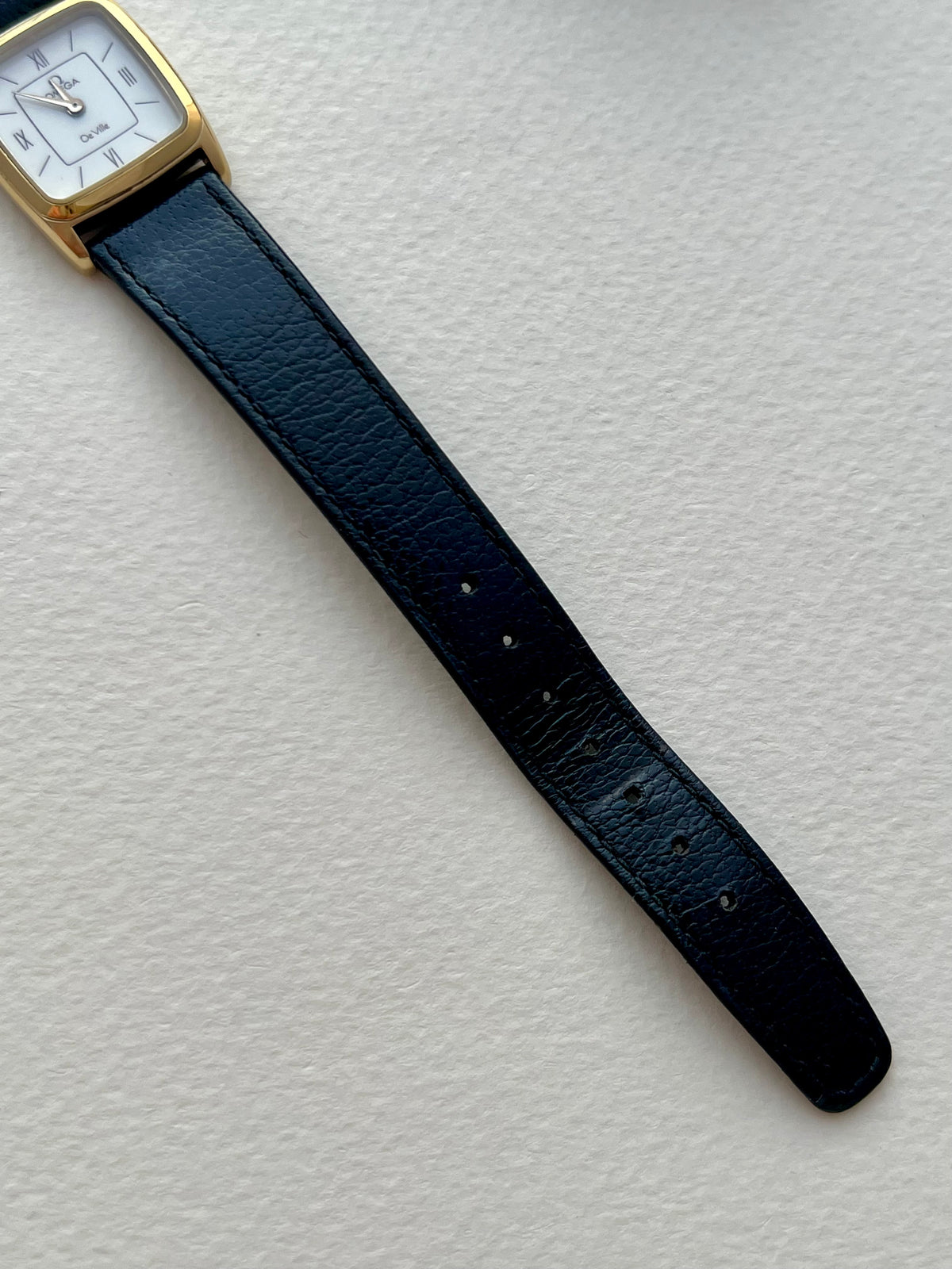 Omega De Ville watch worn on the wrist, showing its compact proportions.