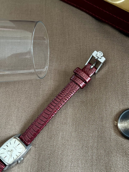 Burgundy embossed aftermarket leather strap with silver tone Omega signed buckle and two keepers