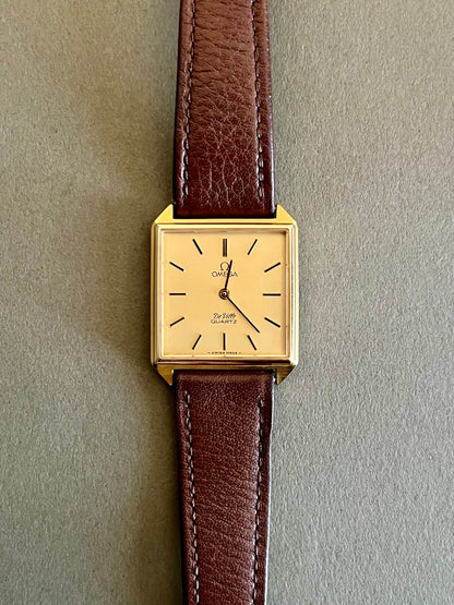 Brown aftermarket leather strap and gold-tone Omega buckle for the De Ville watch.