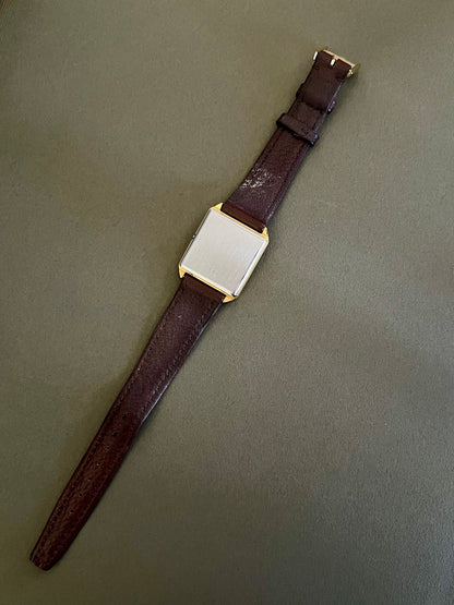 Omega De Ville vintage women's watch with champagne dial and black baton hands.