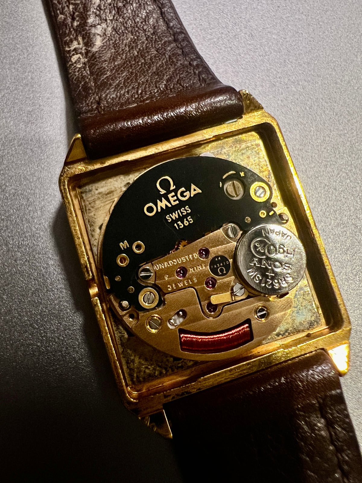 Vintage Omega De Ville gold ladies watch with brown leather strap and champagne dial.