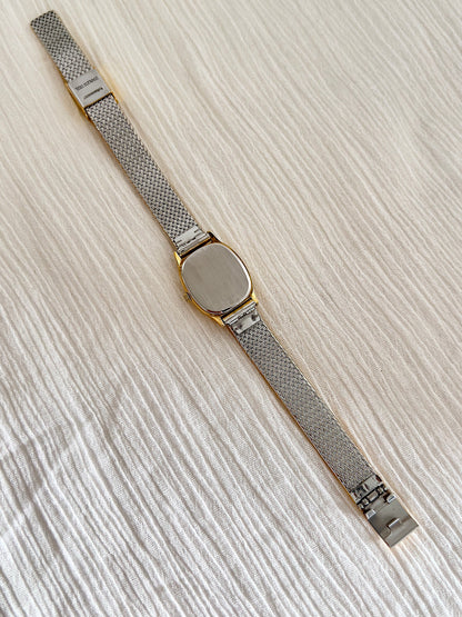 Omega De Ville gold watch shown with its presentation box.