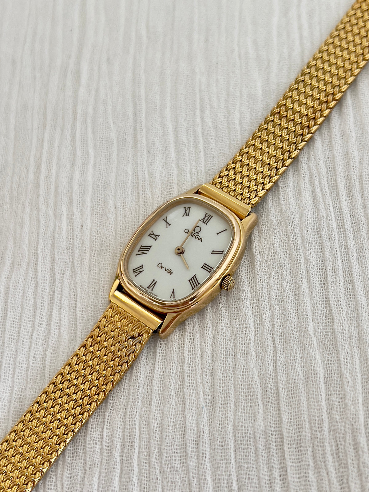 Side profile of the case on the Omega De Ville mesh watch.