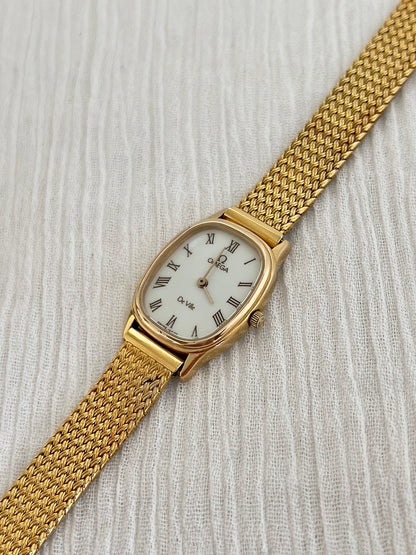 Side profile of the case on the Omega De Ville mesh watch.