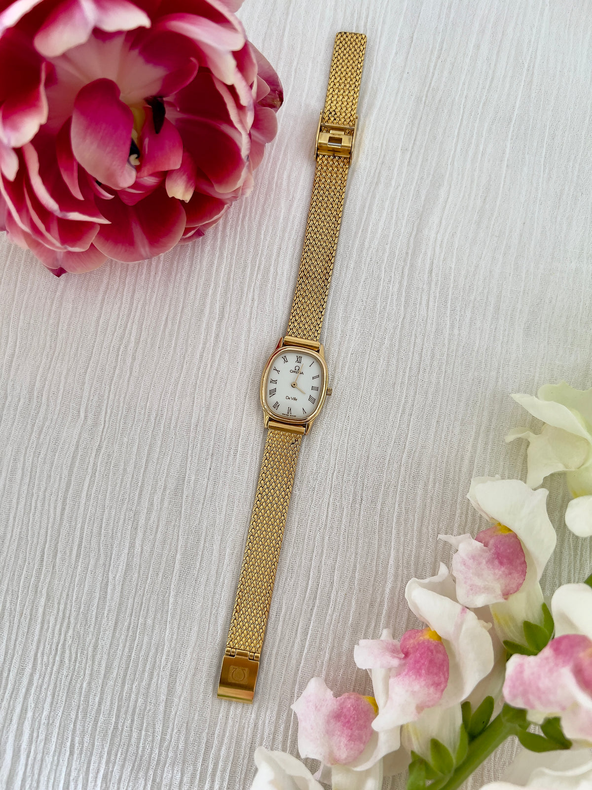 Front view of the Omega De Ville champagne dial watch.