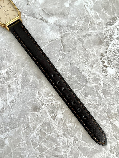 Adjustable dark stitched strap and fit holes on Omega De Ville rectangular watch