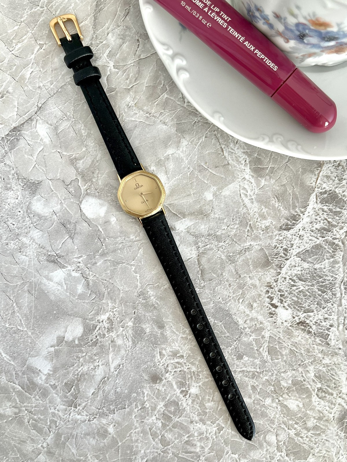 Full-length Omega De Ville gold-tone women's quartz watch with black strap and gold buckle — ref. 591.0257