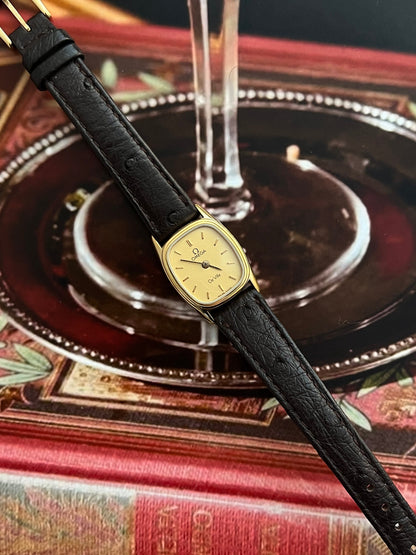 Close-up of the Omega De Ville champagne dial and polished gold-tone hour markers.