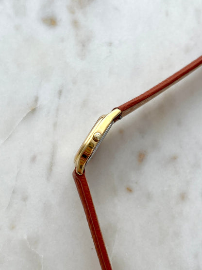 Brown leather strap detail on the Omega De Ville watch.
