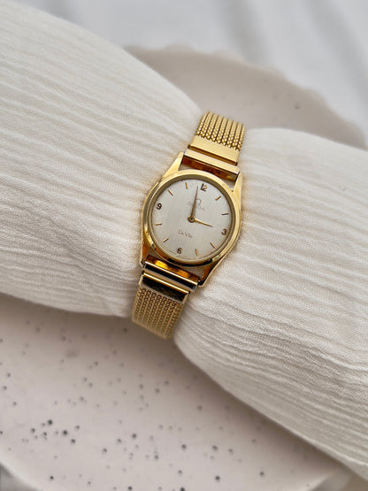 Vintage Omega De Ville round gold-tone watch with minimal silvered dial.