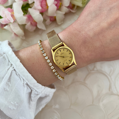 Detail of the aftermarket gold-tone mesh bracelet on the Omega De Ville watch.