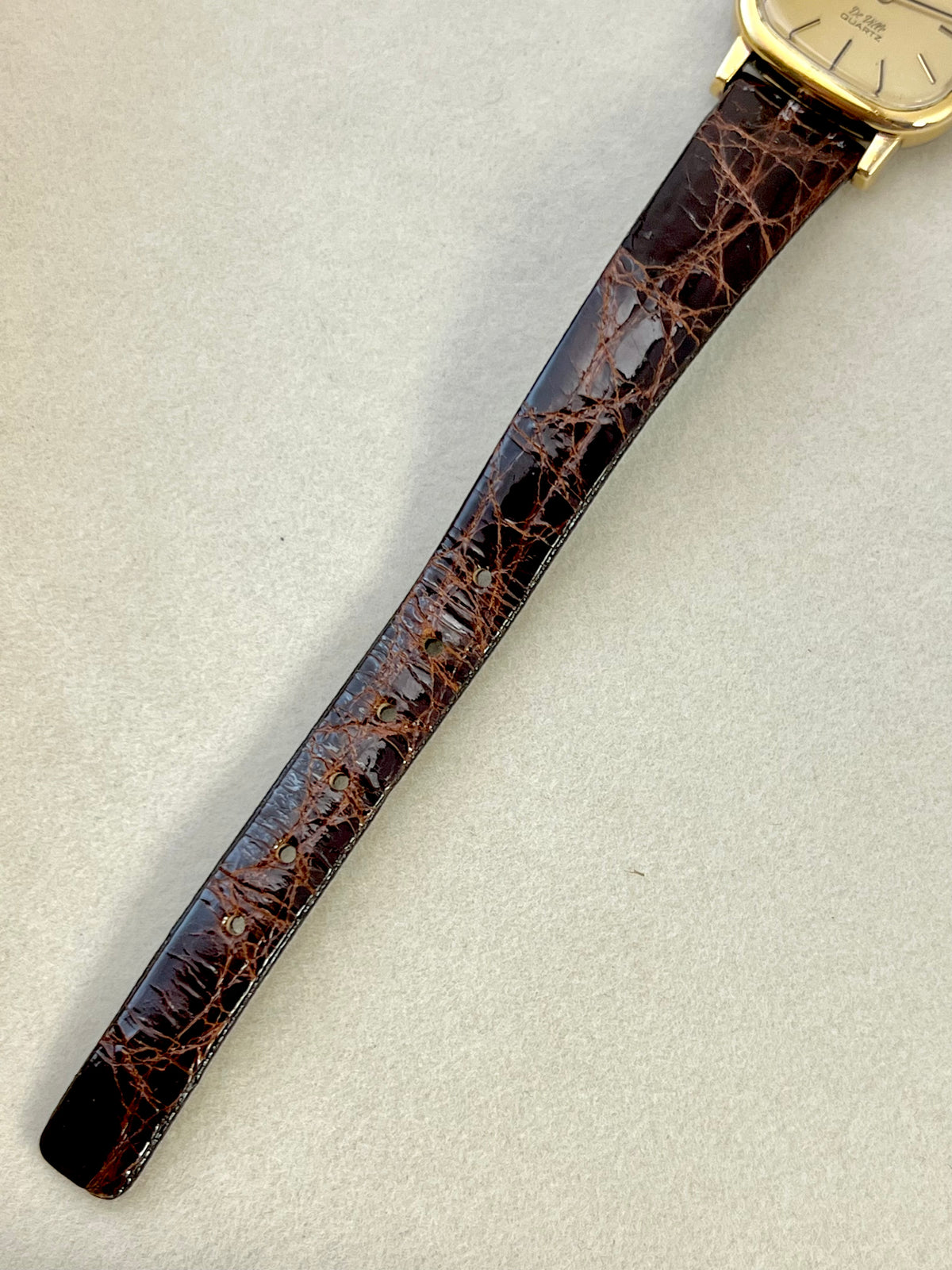 Detail of the Omega De Ville black leather strap.