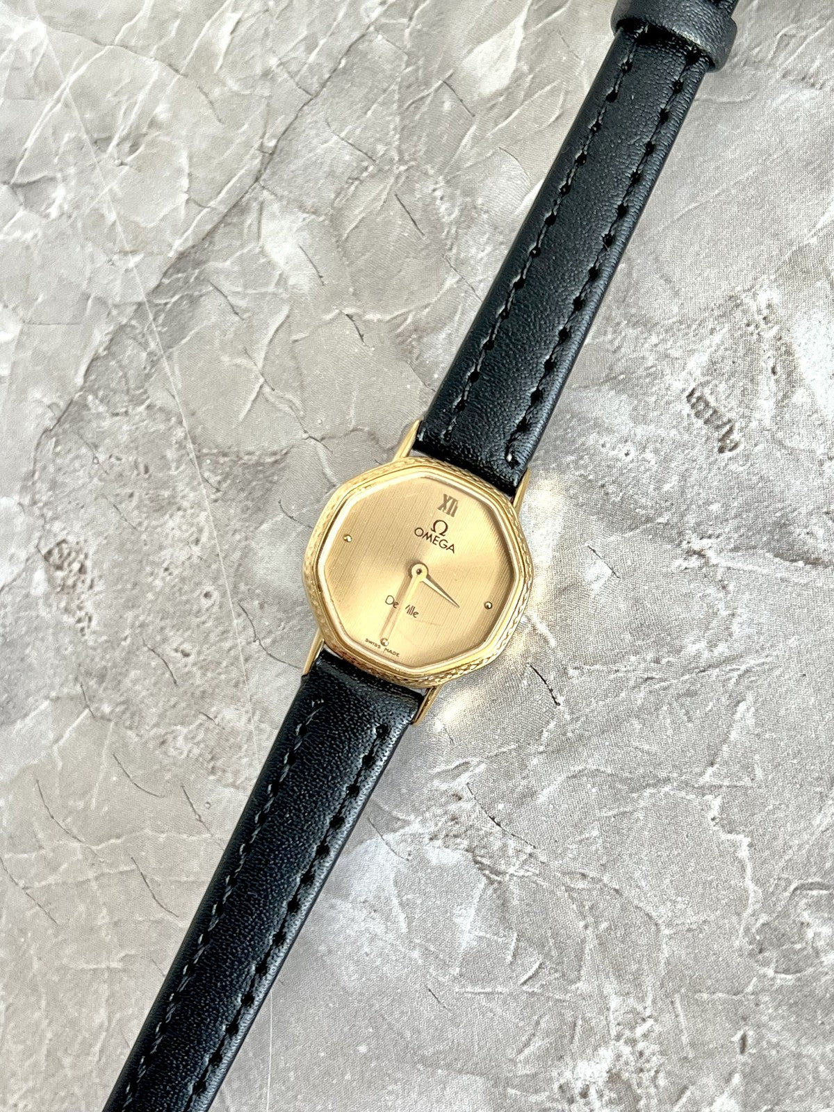 Omega De Ville champagne fine-line dial, Roman XII and dot hour markers on black strap — ref. 591.0257