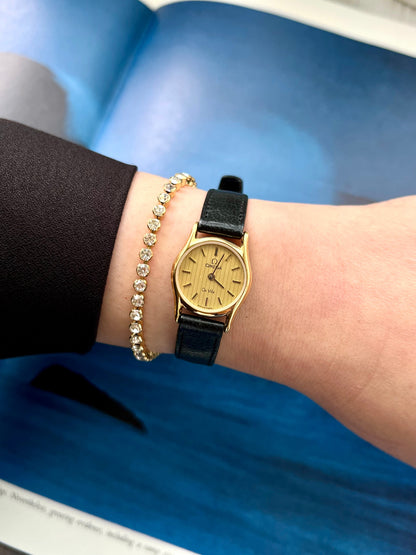 Omega De Ville women's quartz watch with gold-tone case.