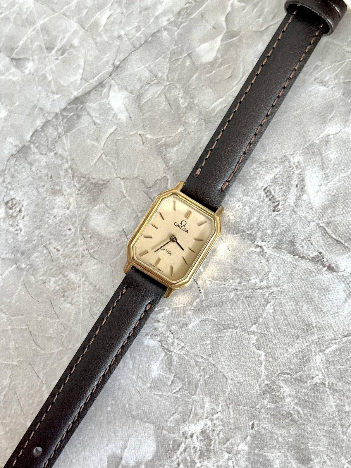 Angled view of Omega De Ville gold-tone clipped-corner rectangular case and champagne dial