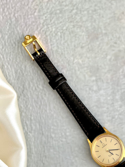 Brown leather strap detail on the Omega De Ville watch.