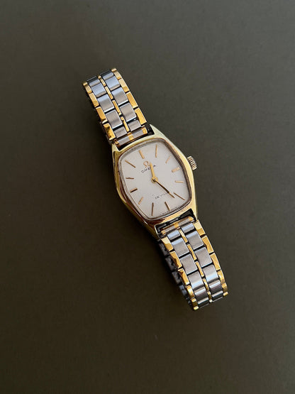 Omega De Ville Gold Woman's Watch with Tonneau Case, angled view of a vintage women's watch at Gilded Hour.
