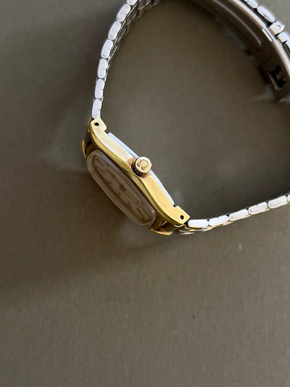 Omega De Ville Gold Woman's Watch with Tonneau Case, bracelet detail of a vintage women's watch at Gilded Hour.