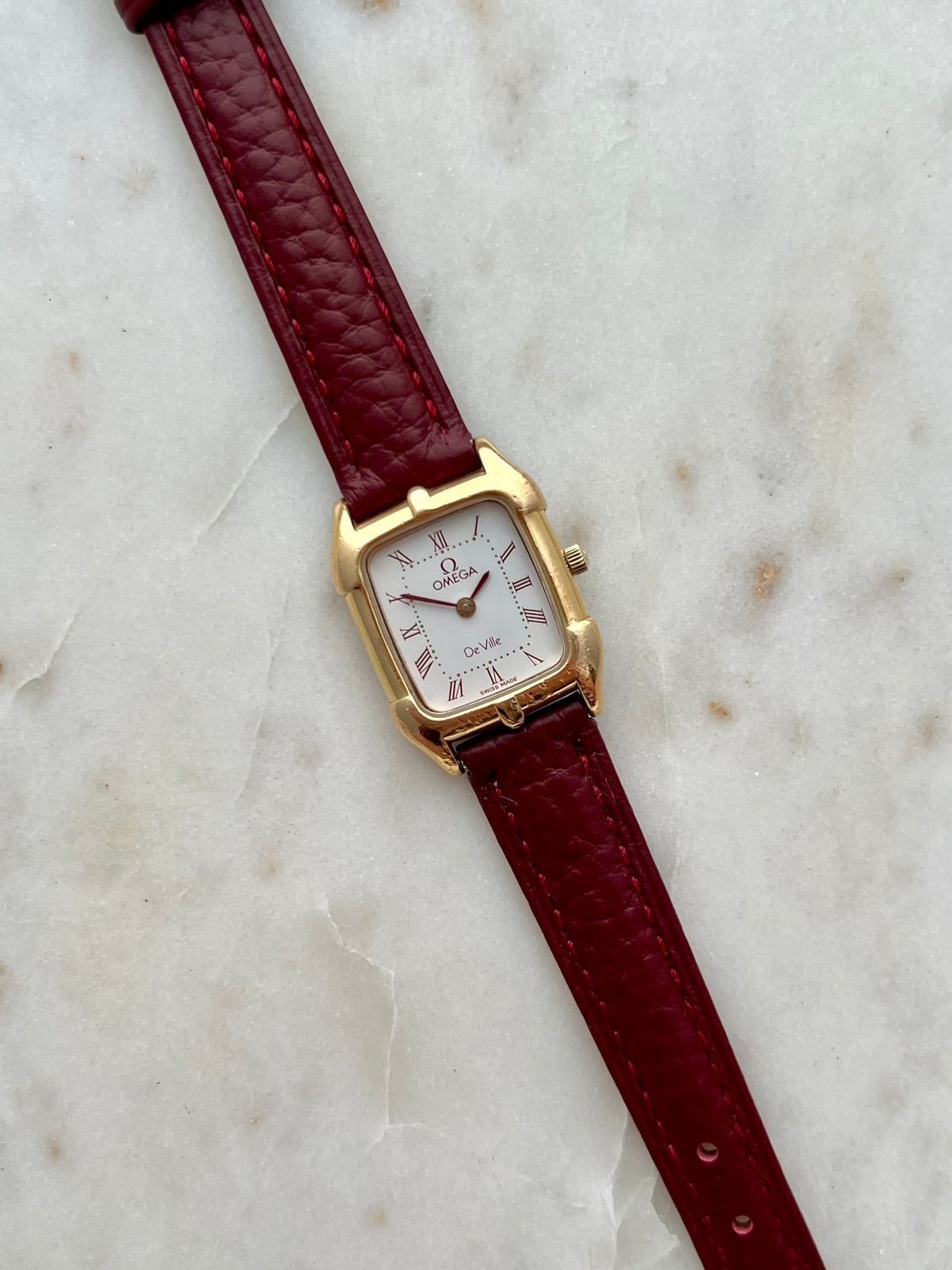 Omega De Ville Burgundy Roman Dial Strap Watch: burgundy Roman dial at an angle.