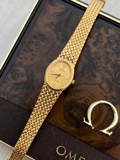 Close-up of the Omega De Ville champagne guilloché dial, Roman numerals and coin-edge bezel.