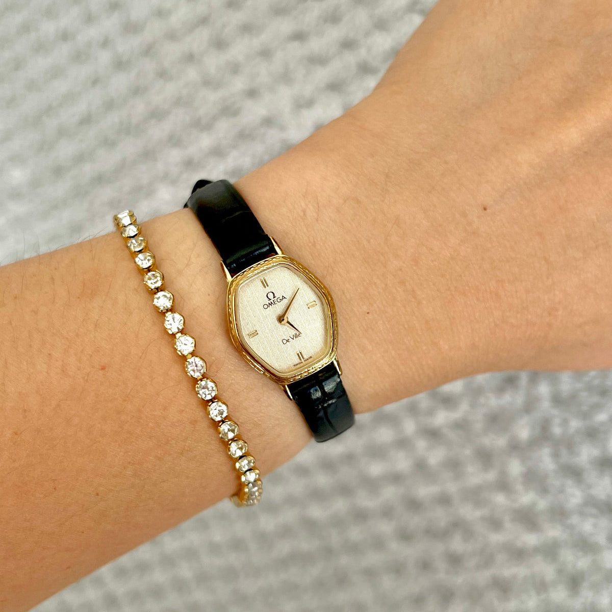 Omega De Ville gold tonneau ladies watch, front view.