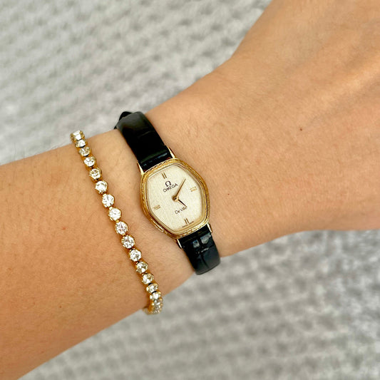 Omega De Ville gold tonneau ladies watch, front view.
