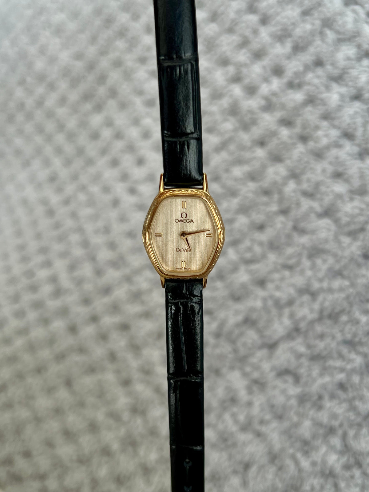 Omega De Ville gold tonneau ladies watch, detail view.