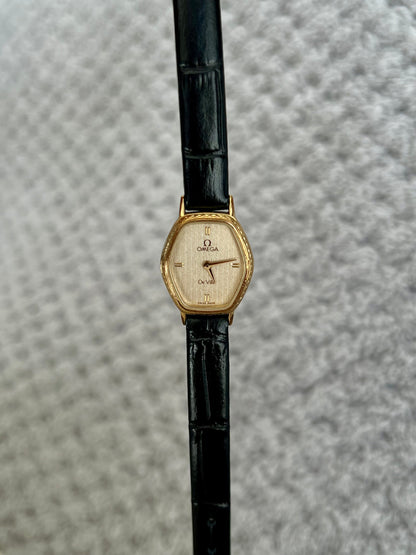 Omega De Ville gold tonneau ladies watch, detail view.
