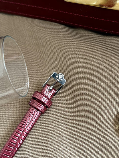 Omega signed silver tone pin buckle on the burgundy aftermarket leather strap