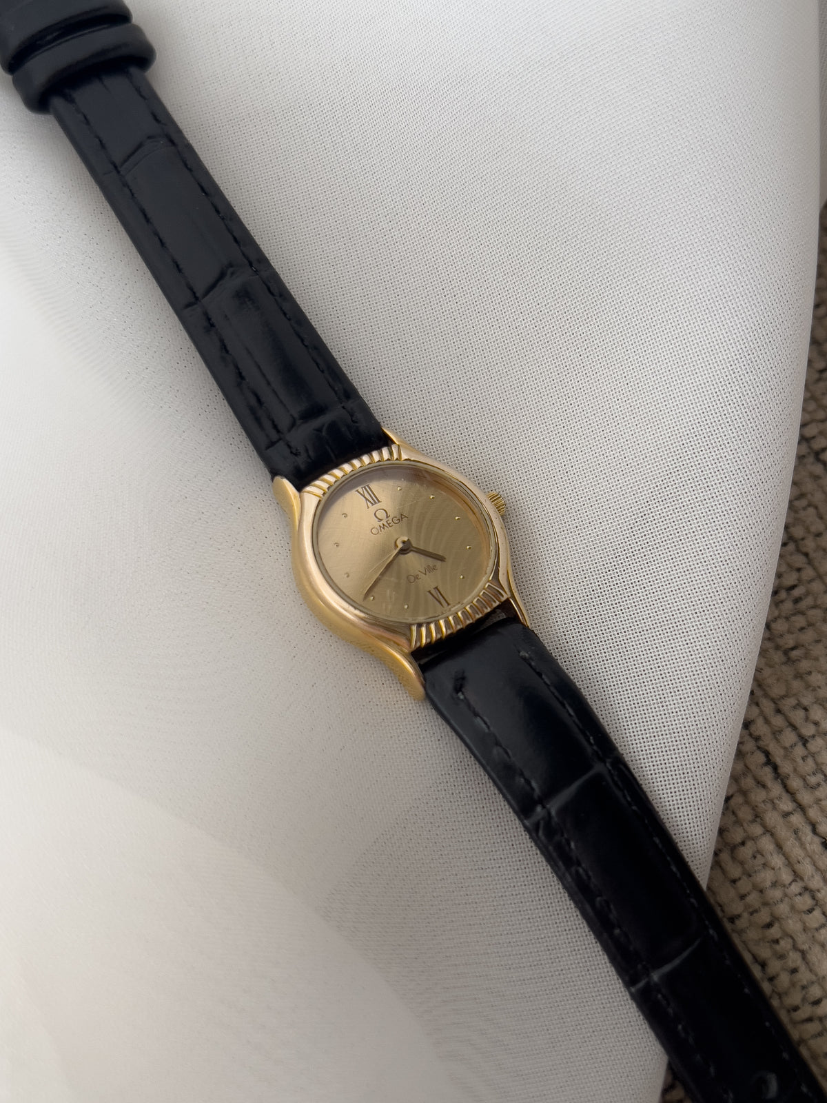 Omega De Ville Gold Woman's Watch with Unique Patterned Dial, angled view of a vintage women's watch at Gilded Hour.