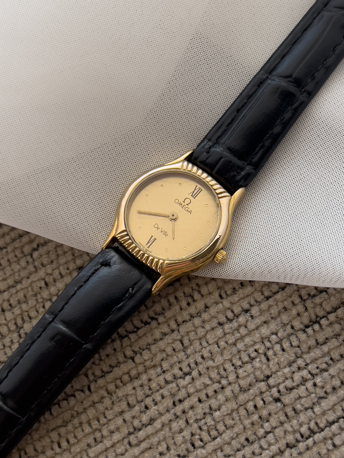 Omega De Ville Gold Woman's Watch with Unique Patterned Dial, wrist shot of a vintage women's watch at Gilded Hour.
