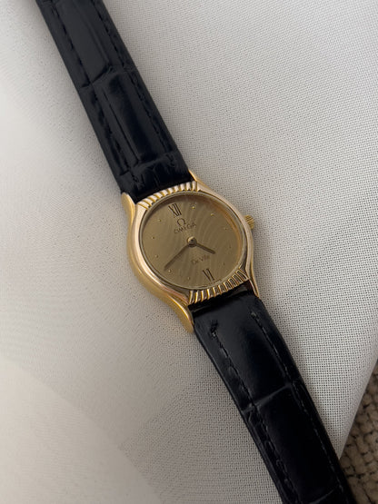 Omega De Ville gold-tone women's watch with patterned dial and black leather strap