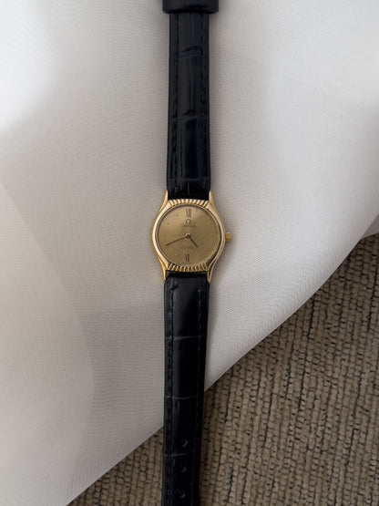 Omega De Ville gold-tone women's watch with patterned dial and black leather strap