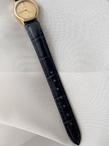 Omega De Ville gold-tone women's watch with patterned dial and black leather strap
