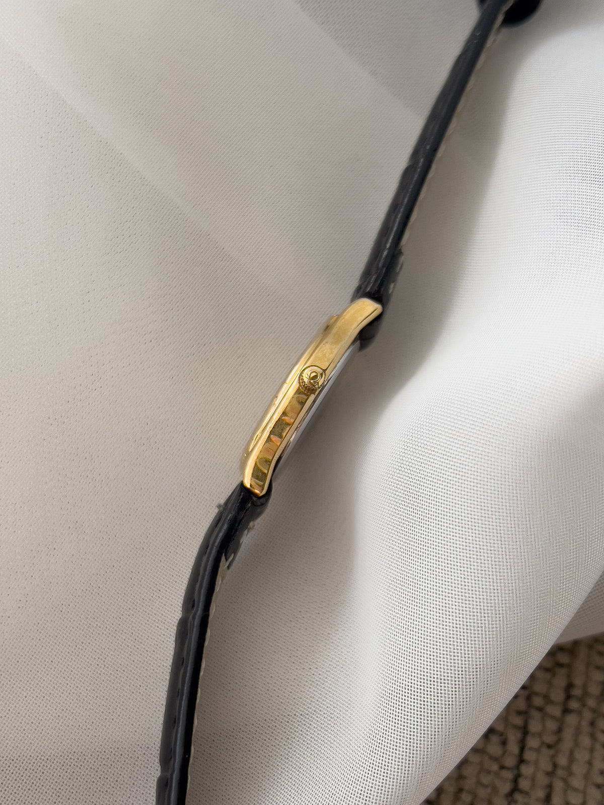 Omega De Ville gold-tone women's watch with patterned dial and black leather strap