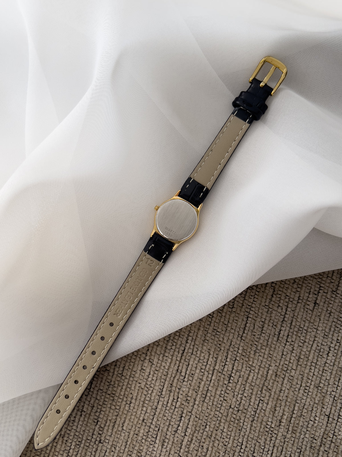 Omega De Ville gold-tone women's watch with patterned dial and black leather strap
