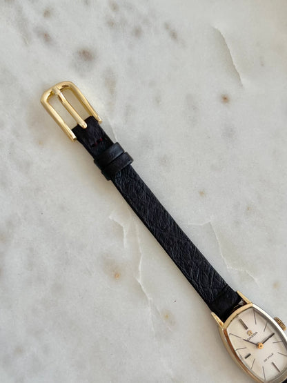 Omega De Ville petite tonneau women’s watch, angled view.