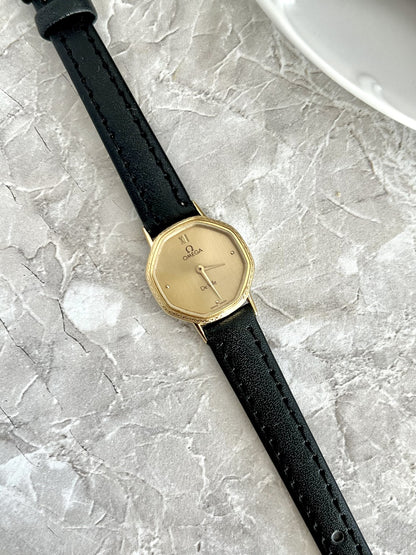 Omega De Ville calibre 1387 quartz watch with champagne dial and black strap, angled detail — ref. 591.0257