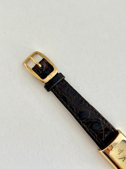 Omega De Ville rectangular watch shown on a wrist.