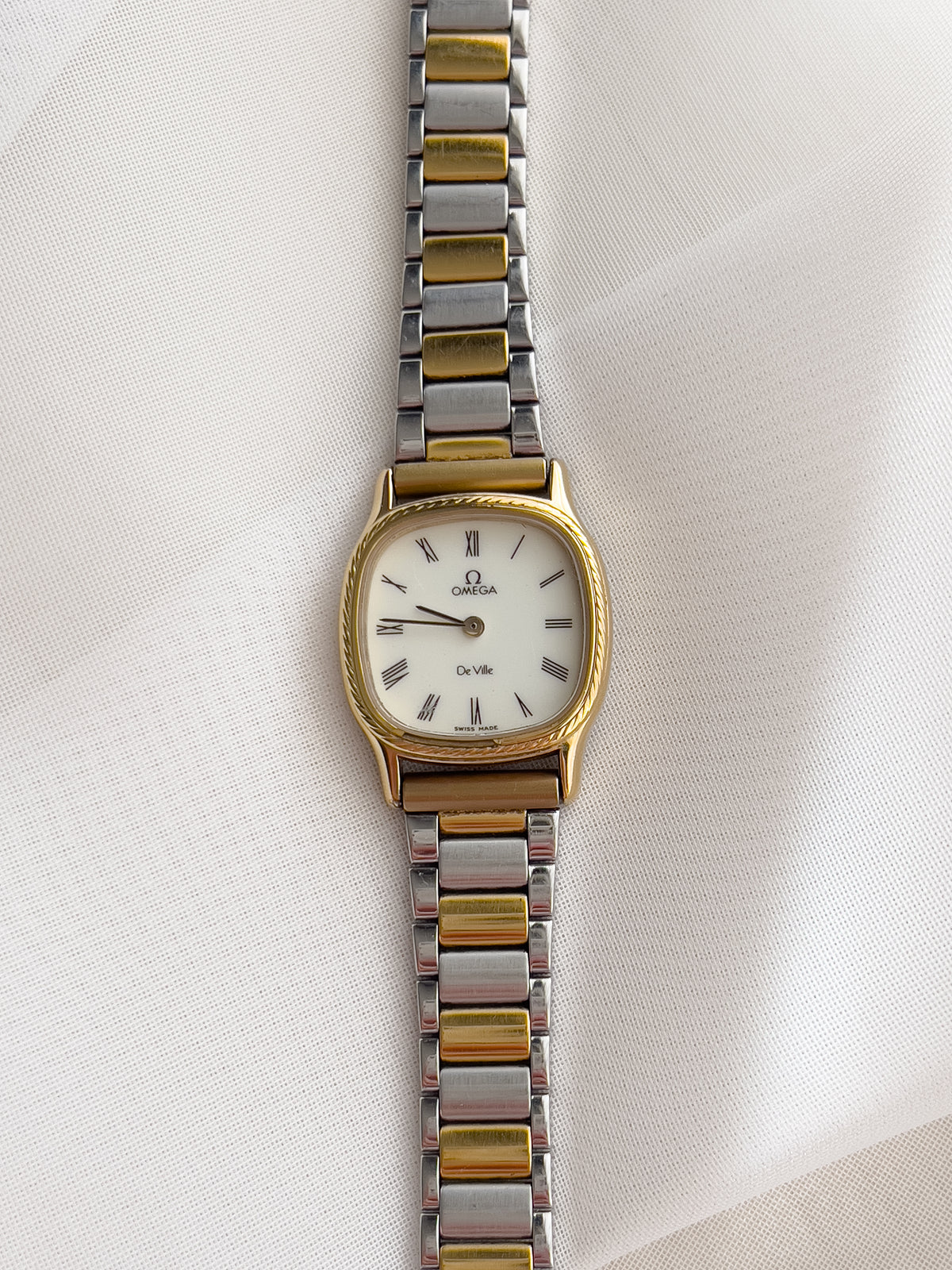 Omega De Ville Cushion Case Woman's Watch with Rope Bezel Pattern, case profile of a vintage women's watch at Gilded Hour.