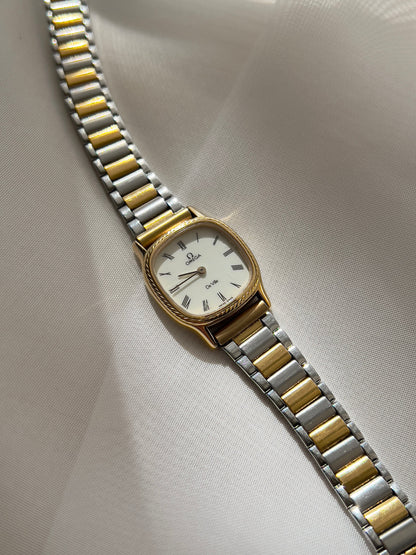Omega De Ville Cushion Case Woman's Watch with Rope Bezel Pattern, angled view of a vintage women's watch at Gilded Hour.